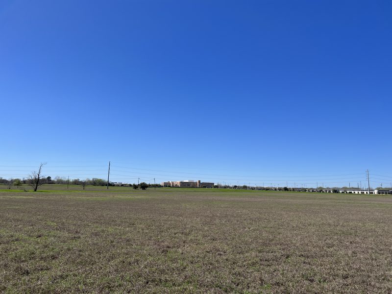 Img 0976 An Open Field With A Veteran Affairs Building In The Background Across The Highway From The Tank Farms Which Will Likely Be Commercial Property In The Near Future 1